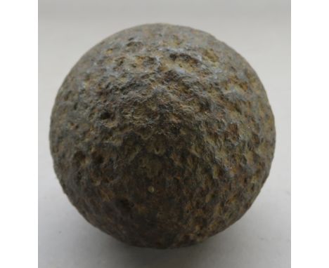 TWO IRON CANNON BALLS, 17TH AND 18TH CENTURY the first for a two pounder gun and the second, in excavated condition, for a si