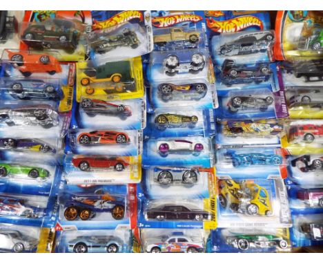 A large collection of approximately 40 diecast model motor vehicles to include Hotwheels, Matchbox, Mattel and other