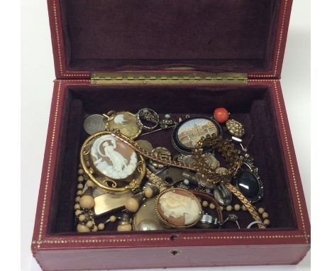 A box containing lockets, stick pins etc. Est. £30 - £40.