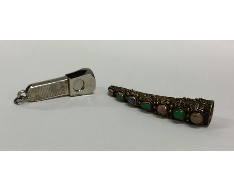 A good quality Continental silver gilt brooch inset with gemstones together with an engine turned cigar cutter. Approx. 44 gr