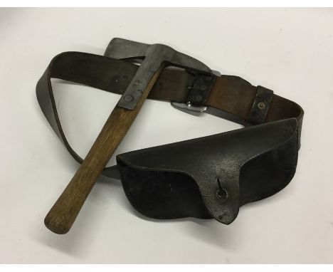 An American firefighter's axe together with a leather belt and sheath. Est. £40 - £60.