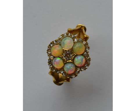 A large Edwardian opal and diamond circular cluster ring in claw mount with large central stone. Approx. 6.6 grams. Est. £800