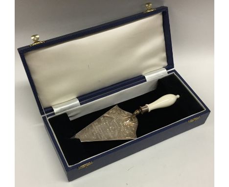 A cased silver presentation trowel engraved with flowers. Presented by 'David Charles to The Prime Minister, The Rt. Hon. Har