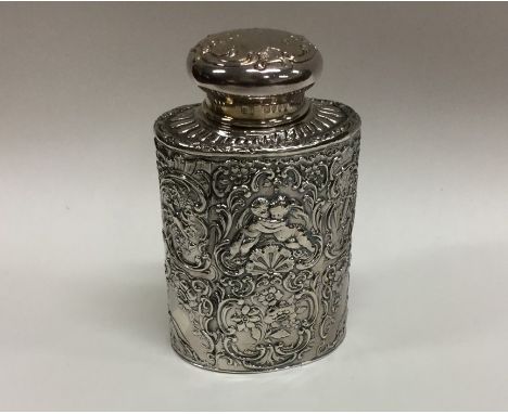 An embossed oval silver top tea caddy decorated with cherubs. Approx. 110 grams. Est. £50 - £80.