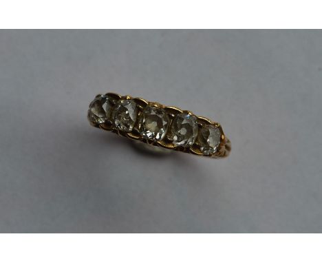 An 18 carat gold diamond five stone carved half hoop ring in claw mount. Approx. 4 grams. Est. £400 - £600.