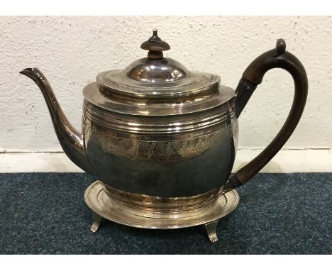 A good Georgian silver bright cut teapot on stand engraved with flowers and leaves. London. Est. £500 - £800.