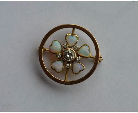 An opal and diamond circular brooch of heart shaped form with large central diamond. Approx. 5 grams. Est. £300 - £400.
