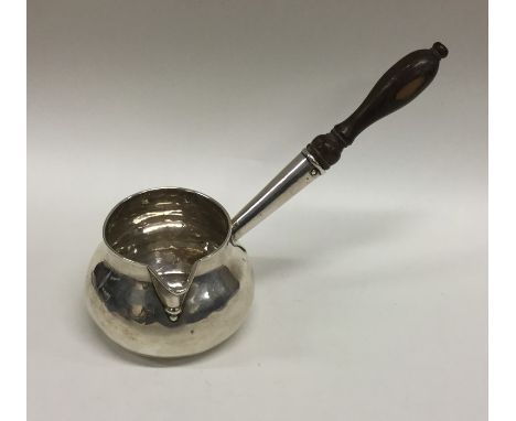 A Georgian silver brandy pan with turned wooden handle. London. By JC? Approx. 93 grams. Est. £250 - £300.