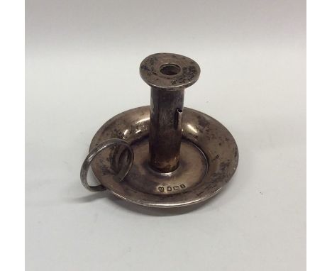 A circular miniature silver chamber stick. Birmingham. Approx. 39 grams. Est. £25 - £35.