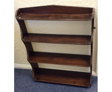 A mahogany tapering shelf with reeded sides. Est. £25 - £35.