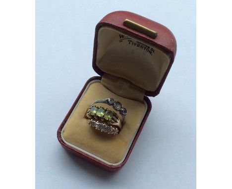 A peridot three stone ring together with a diamond five stone ring in 18 carat gold mount. Est. £100 - £150.