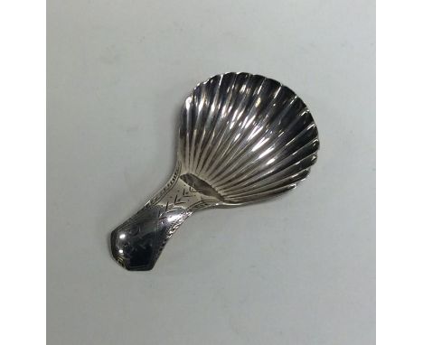 A good Georgian silver fluted caddy spoon with bright cut decoration. London. By IT. Approx. 7 grams. Est. £50 - £80.