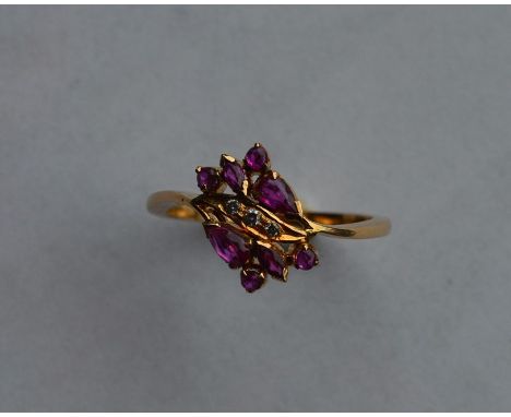 A French ruby and diamond cocktail ring set in 18 carat gold. Approx. 3 grams. Est. £80 - £120.