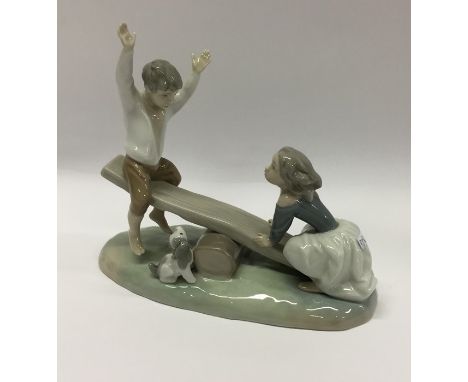A Lladro figure of children upon a see-saw. Est. £20 - £30.
