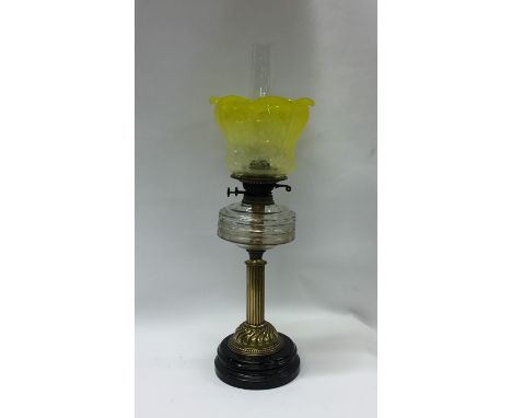 An attractive brass mounted oil lamp with etched yellow vaseline shade. Est. £60 - £80.