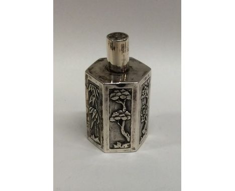 A Chinese silver miniature tea caddy with floral decoration. Approx. 28 grams. Est. £40 - £60.