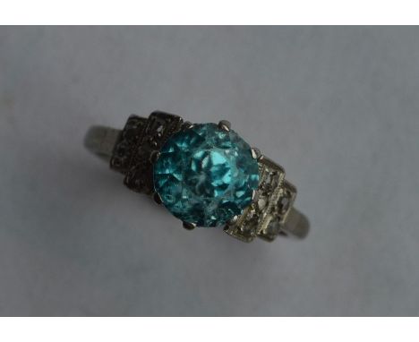 A stylish zircon single stone ring in Art Deco platinum claw mount. Approx. 4 grams. Est. £500 - £600.