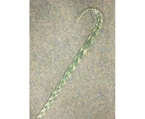 A green glass twisted walking stick. Est. £15 - £20.