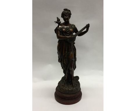 A large spelter figure of a lady playing a mandolin. Est. £15 - £20.