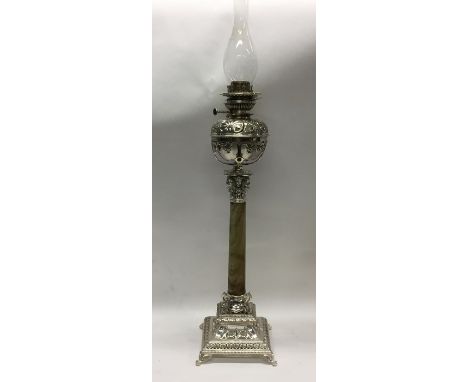 A massive silver plated and onyx oil lamp decorated with scrolls and flowers. Est. £100 - £200.