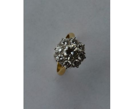 A large circular diamond daisy head cluster ring set in gold and platinum claw mount. Approx. 5.6 grams. Est. £2000 - £3000.