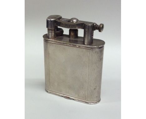 A massive engine turned Dunhill table lighter. Est. £120 - £150.