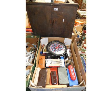 A collection of vintage boxed and unboxed darts together with a vintage dart board and wall clock (2)