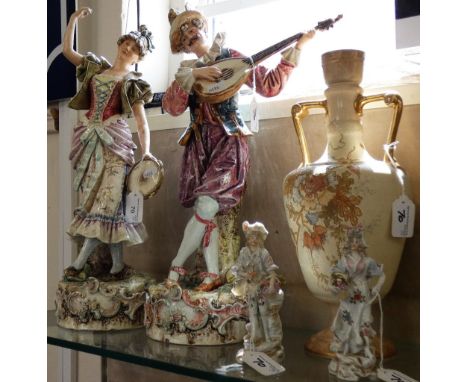 A pair of musician figures, the male playing a mandolin, the dancing female with tambourine, 55 cm tall, together with a smal