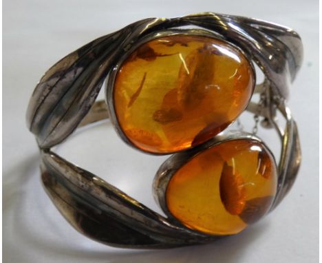 A silver and amber bangle of naturalist form