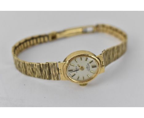 A Rotary 9ct gold ladies wristwatch, with an oval batten dial, on a textured, flexible strap, 15.3g total 