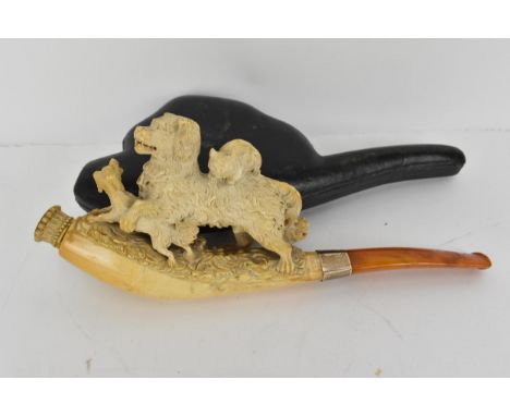 A late 19th century Meerschaum pipe with a gold band, the bowl surmounted by a cat sitting on top of a dog who is playing wit