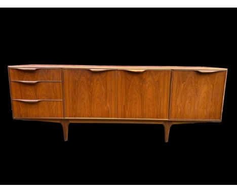 A 1960's teak sideboard by Tom Robertson for McIntosh of Kirkaldy, with three graduated drawers, a fall-front cupboard door, 