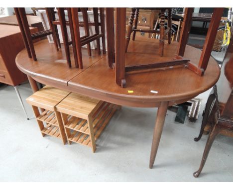 A vintage teak extending dining table