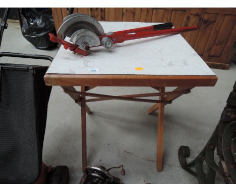 A traditional folding card table having formica top