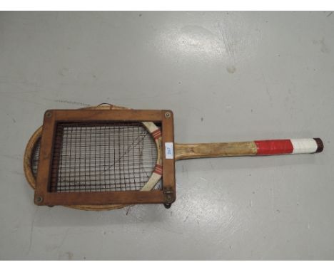 A vintage tennis racket and head guard