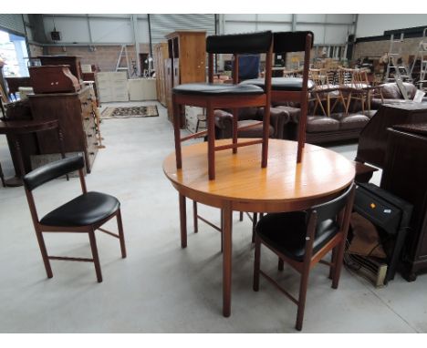 A vintage circular extending dining table and six chair by MacIntosh