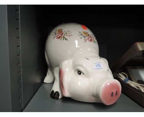 A large floral ceramic piggy bank