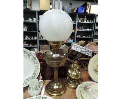 A vintage brass oil lam and similar electric table lamp