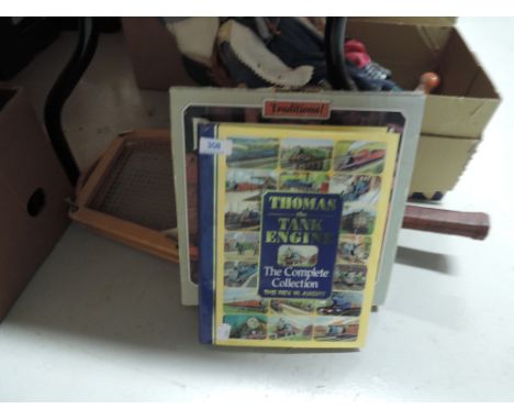 A vintage tennis racket, dice conpendium, and a volume the complete Thomas the Tank Engine collection