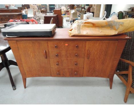 A vintage red oak sideboard or drinks cabinet with 60's design work 
