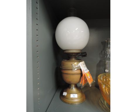 A vintage oil lamp with a milk glass globe