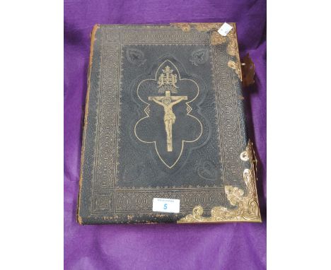 A vintage Family bible with brass decoration and claspsColour text thoughout