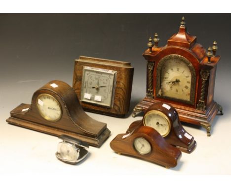 An early 20th century mahogany mantel clock of small proportions; an oak Napoleon hat mantel clock; an oak cased barometer; e