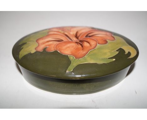 Moorcroft lidded trinket box in the Coral Hibiscus pattern, length 13cm