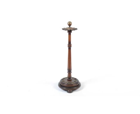 A Victorian oak cue stand, the brass ball finial over a turned column raised on a circular base on three squat bun feet, fitt