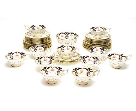 A Coalport bone china part tea service, circa 1900, each piece printed and painted with pink rosebuds within blue and gilt sc