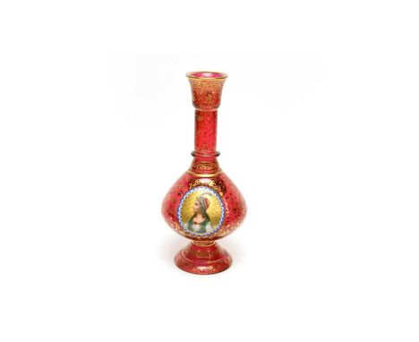 A Bohemian overlay ruby glass vase of mallet shape with spayed foot, overlaid with oval panels in white glass, painted with a