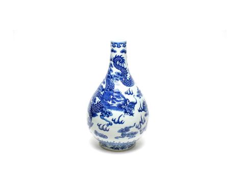 A Chinese blue and white dragon vase, Qing, of bottle form, decorated with a dragon, flaming pearl and clouds, ruyi head bord