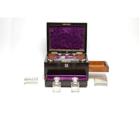 A 19th Century coromandel wood toilet box, with mother-of-pearl escutcheon and cartouche, opening to reveal fitted interior w