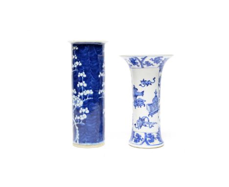 A Chinese blue and white trumpet-shaped vase, Qing, decorated with panels of Buddhistic emblems and antiques, on a foliate sc